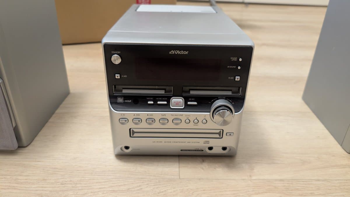 Victor UA-W888 MiniDisc micro component stereo system with dual cassette, CD, and MD decks on wooden surface.