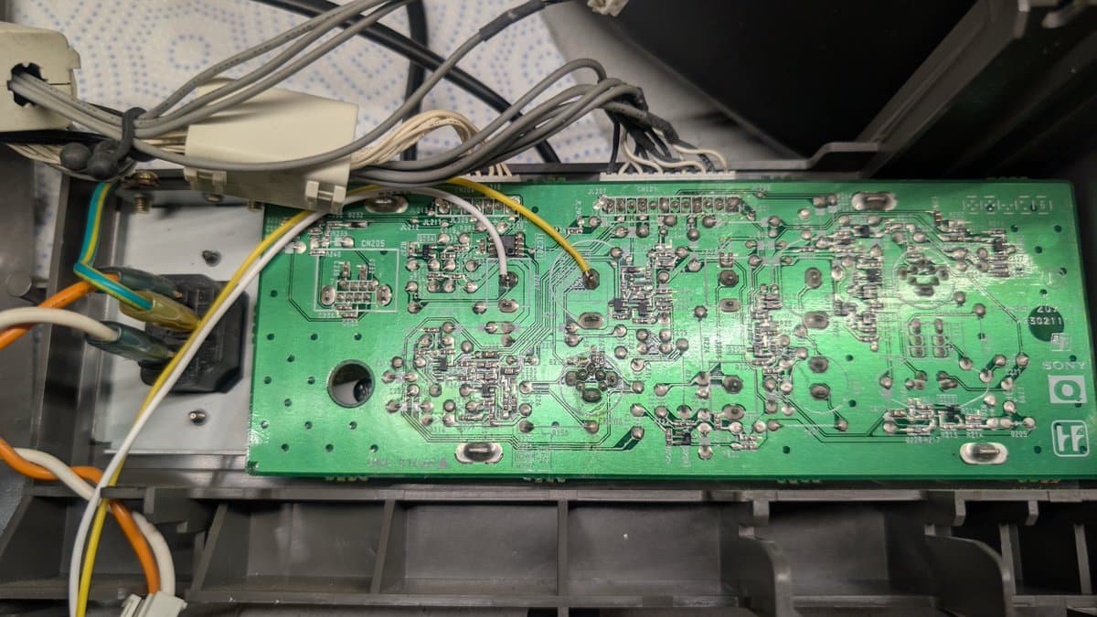 Sony PVM-14L1 RGB mod PCB with soldered wires and connectors, heat-shrink wrapped joints visible during sound and sync wiring installation.