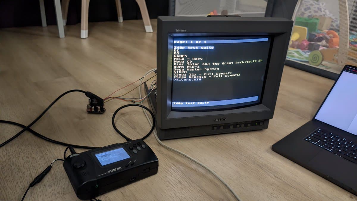 Sony PVM-14L1 CRT displaying RGB test menu with Sega Nomad connected via modded RGB cable, showing game library list on screen.