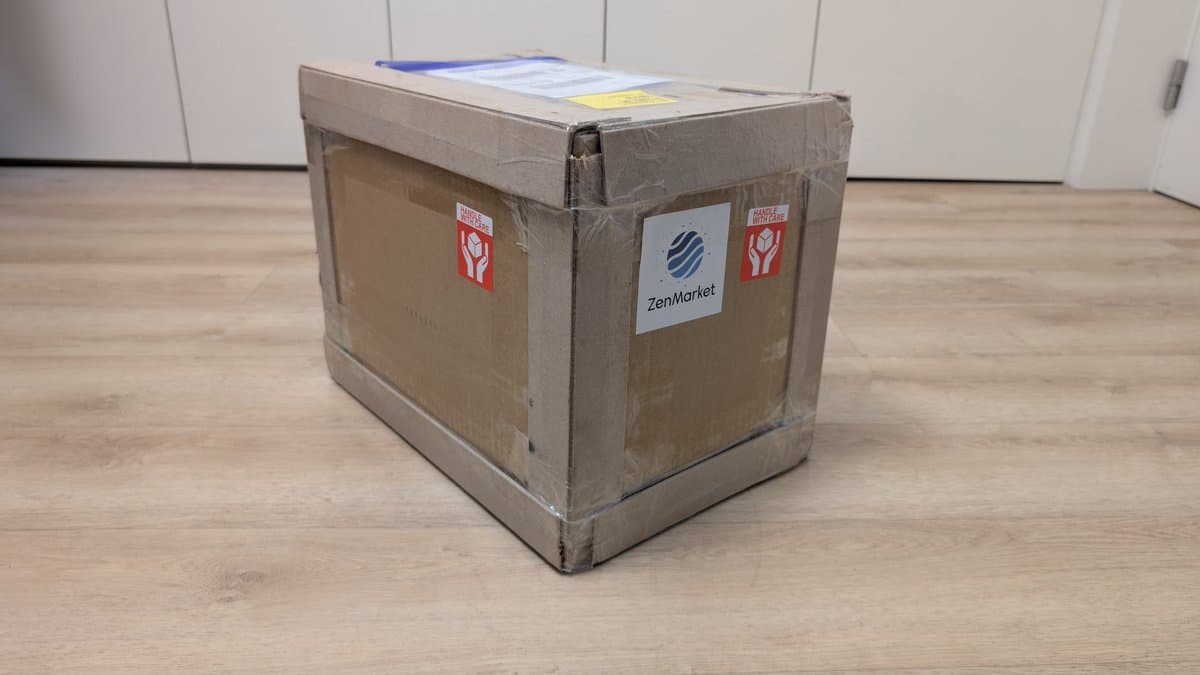 Cardboard shipping box labeled "ZenMarket" with red "Handle with Care" stickers, containing a Sony PVM-6041Q CRT monitor from Japan.