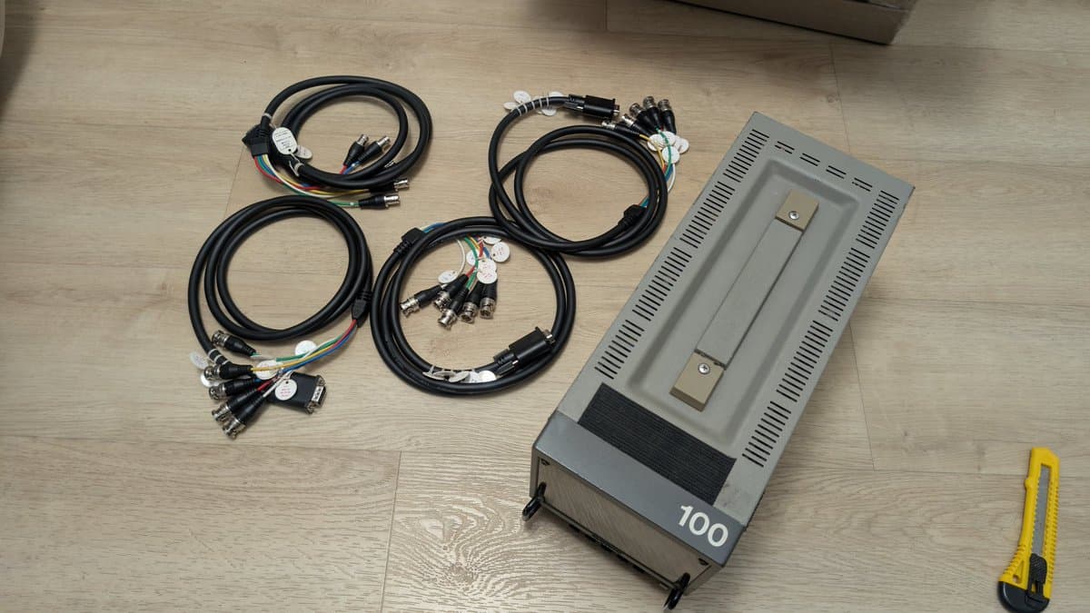 Sony PVM-6041Q 6" CRT monitor with four VGA to BNC cables laid out on wooden floor, yellow measurement tool visible.