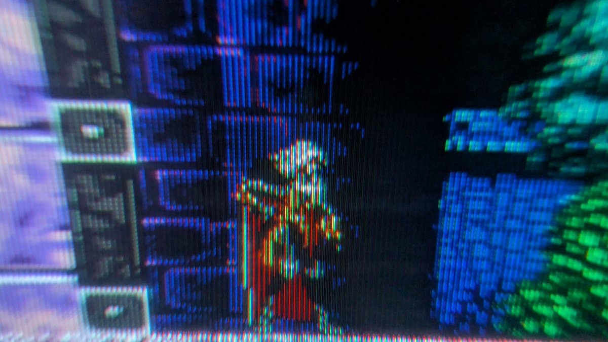 Sony PVM-6041Q CRT displaying colorful test pattern with vertical scanlines; small professional monitor showing restored picture quality after repair.