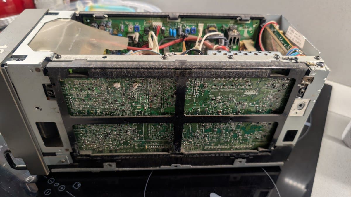 Sony PVM-6041Q interior showing four circuit boards with visible dust accumulation, power supply components, and wiring requiring cleaning and refurbishment.
