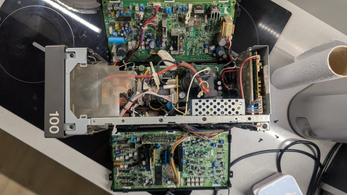Interior of Sony PVM-6041Q showing dust accumulation, multiple PCBs, PSU components, and wiring before cleaning and refurbishment.