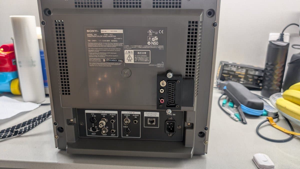 Rear panel of Sony PVM-14L1 showing RGB mod connections, audio output jacks, and toggle switch for mono/stereo audio routing to internal speaker or RCA outputs.