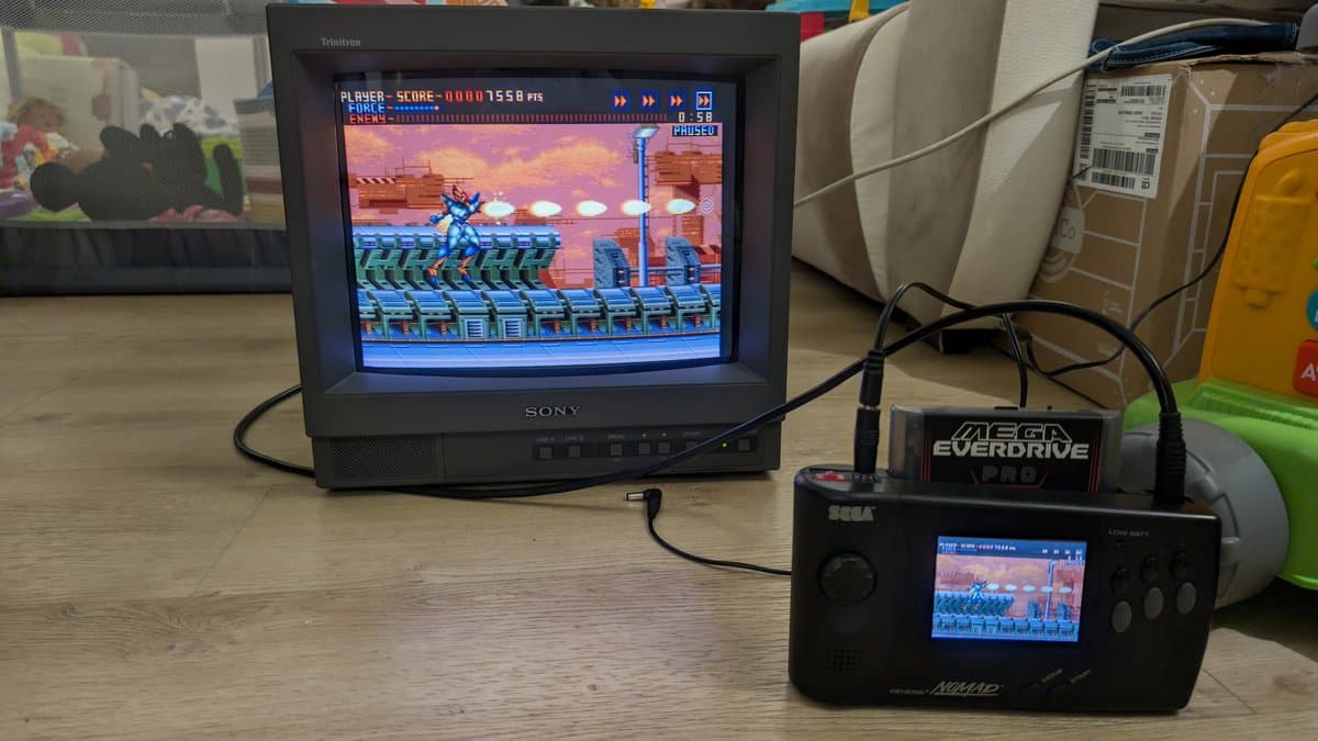 Sony PVM-14L1 CRT displaying Sega Genesis game with RGB mod enclosure featuring toggle switches for audio routing to speaker and RCA outputs.