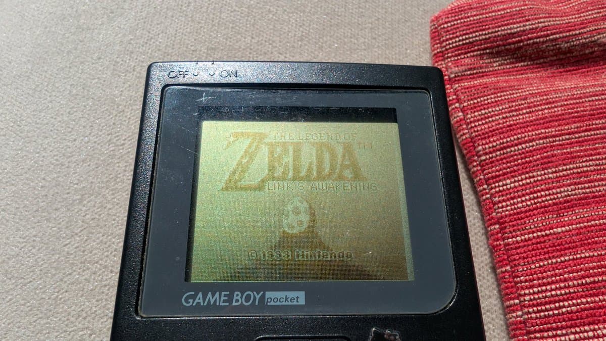 Game Boy Pocket displaying Zelda: Link's Awakening title screen on restored LCD after capacitor replacement and cleaning restoration work.