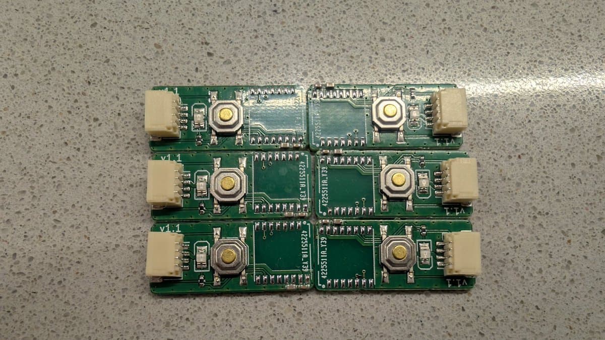 Three assembled WavePhoenix receiver PCBs stacked, showing soldered EFR32 microcontrollers, connector pads, and circuit traces on green boards.