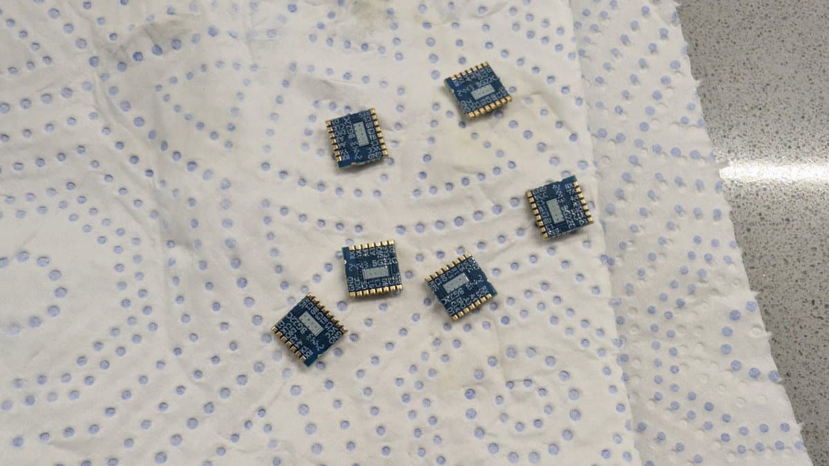 Six tinned EFR32 microcontroller modules arranged on an anti-static mat for WavePhoenix receiver assembly.
