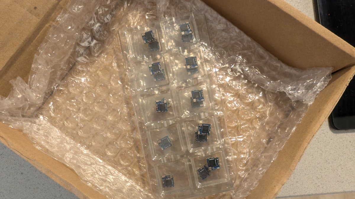 WavePhoenix PCBs in bubble wrap showing soldered components and blue integrated circuits during hot air reflow assembly work.