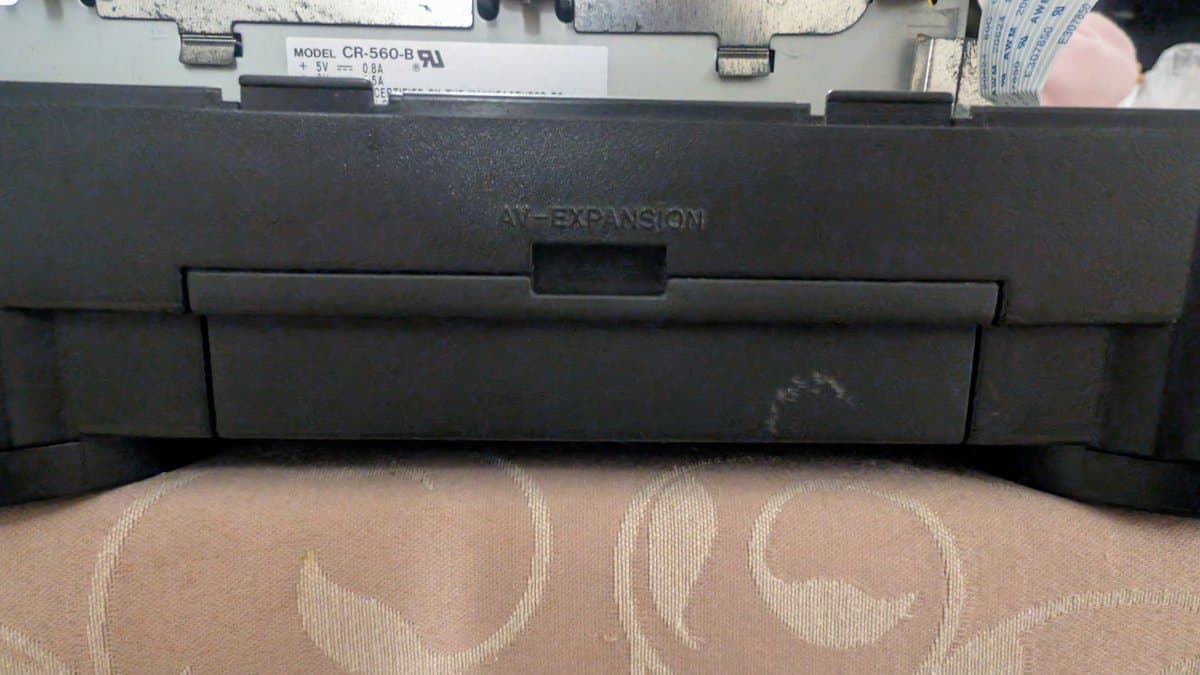 Panasonic FZ-1 3DO with AV expansion module removed, showing CB-560-B power board labeled +5V 0.6A, unit on patterned surface.