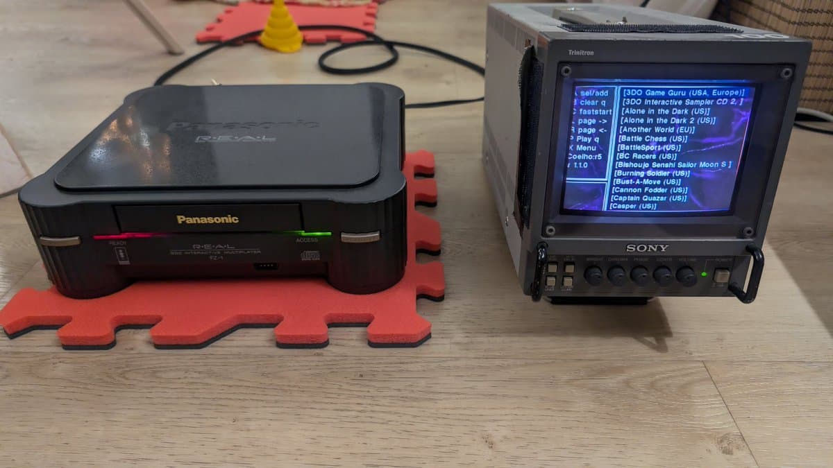 Panasonic FZ-1 3DO with ODE installed, displayed next to Sony monitor showing game menu. Red foam mat visible.