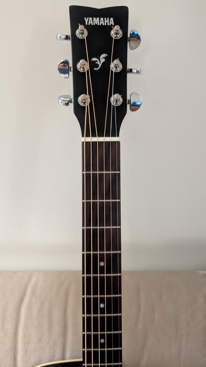 Yamaha FX370C headstock with six chrome tuning pegs and new strings installed, fretboard cleaned and conditioned.