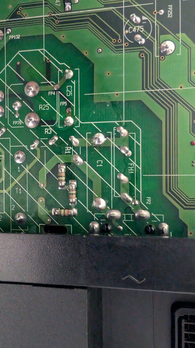 Close-up of B&O Beovision 1 PCB showing replaced X2 safety cap (KEMET), refreshed solder joints, and component labels including R25, FP4, FP5, T4, and various capacitors.